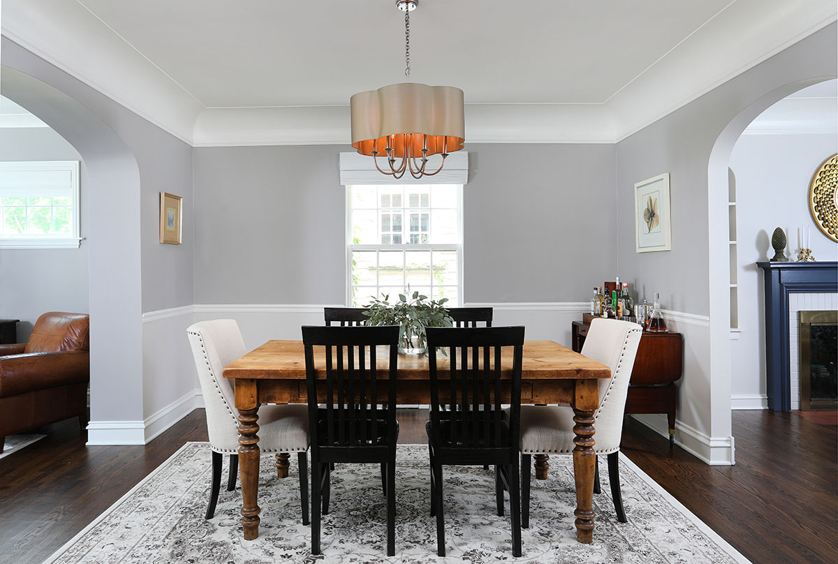 Neutral dining room. gray paint. crown molding, wood floors