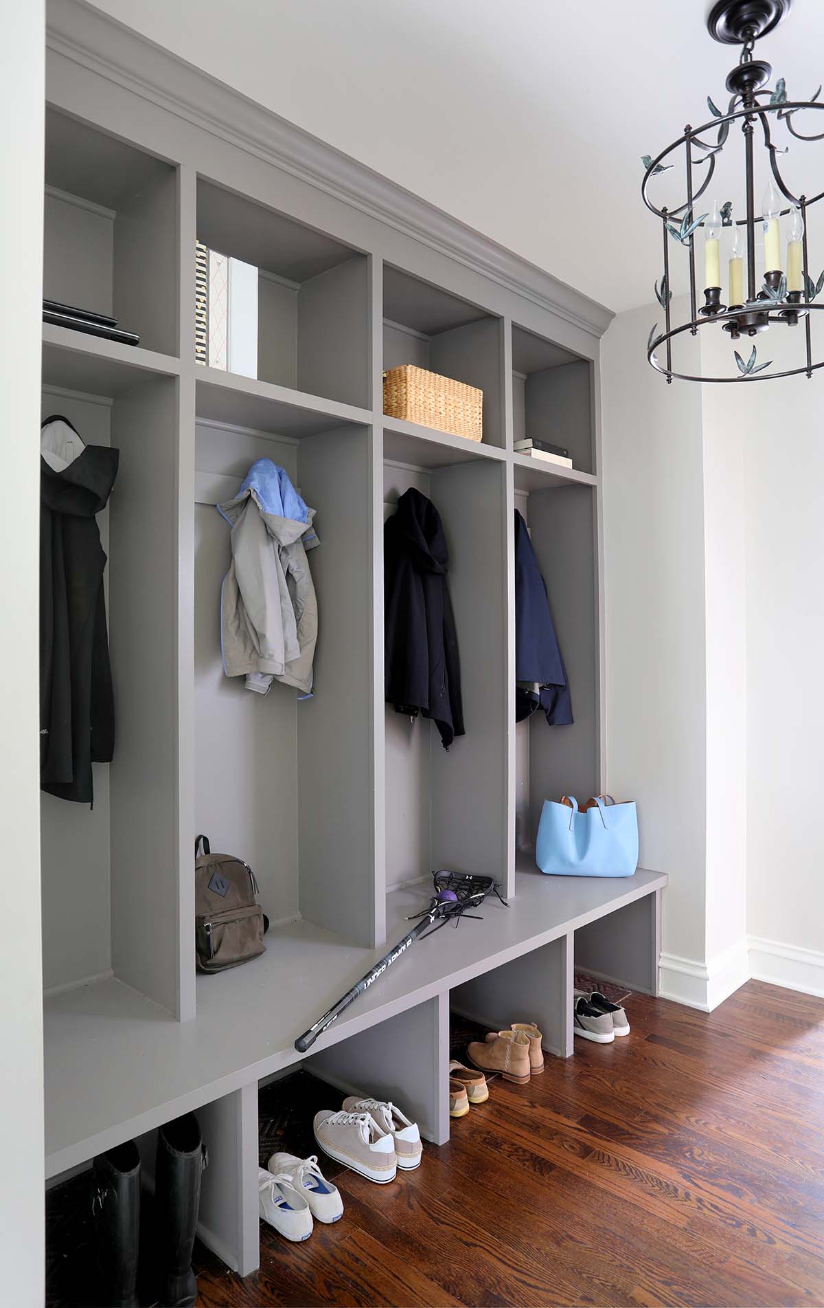 mudroom, cubbies, shelves, gray cabinets, wood floor