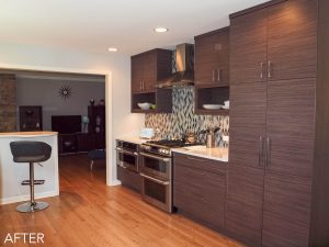 Dark textured cabinets, sleek hardware, stainless range and hood