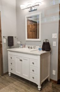 bathroom vanity with decorative cabinetry feet