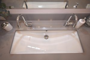 two faucets with one sink