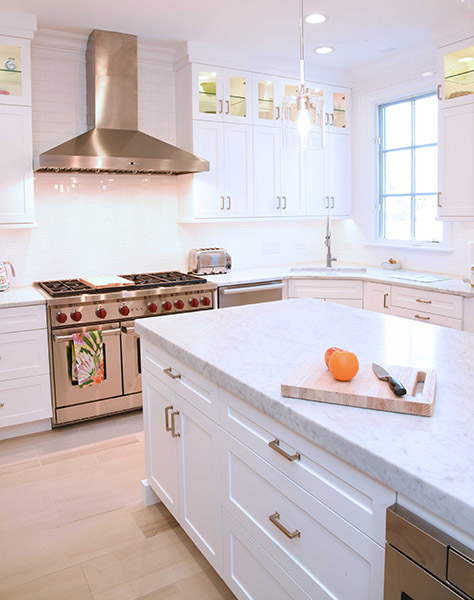 White Painted Kitchen with Wolf Range and Marble Countertops