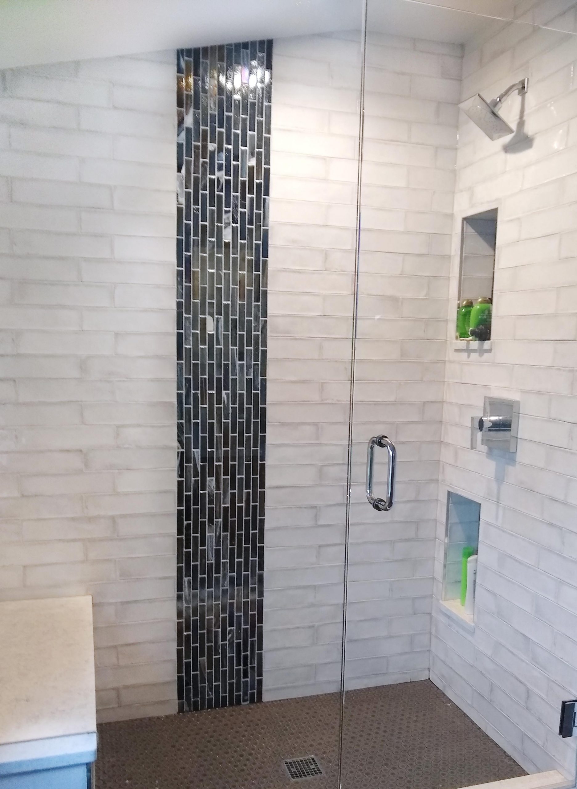 Vertical band of accent tile in the shower