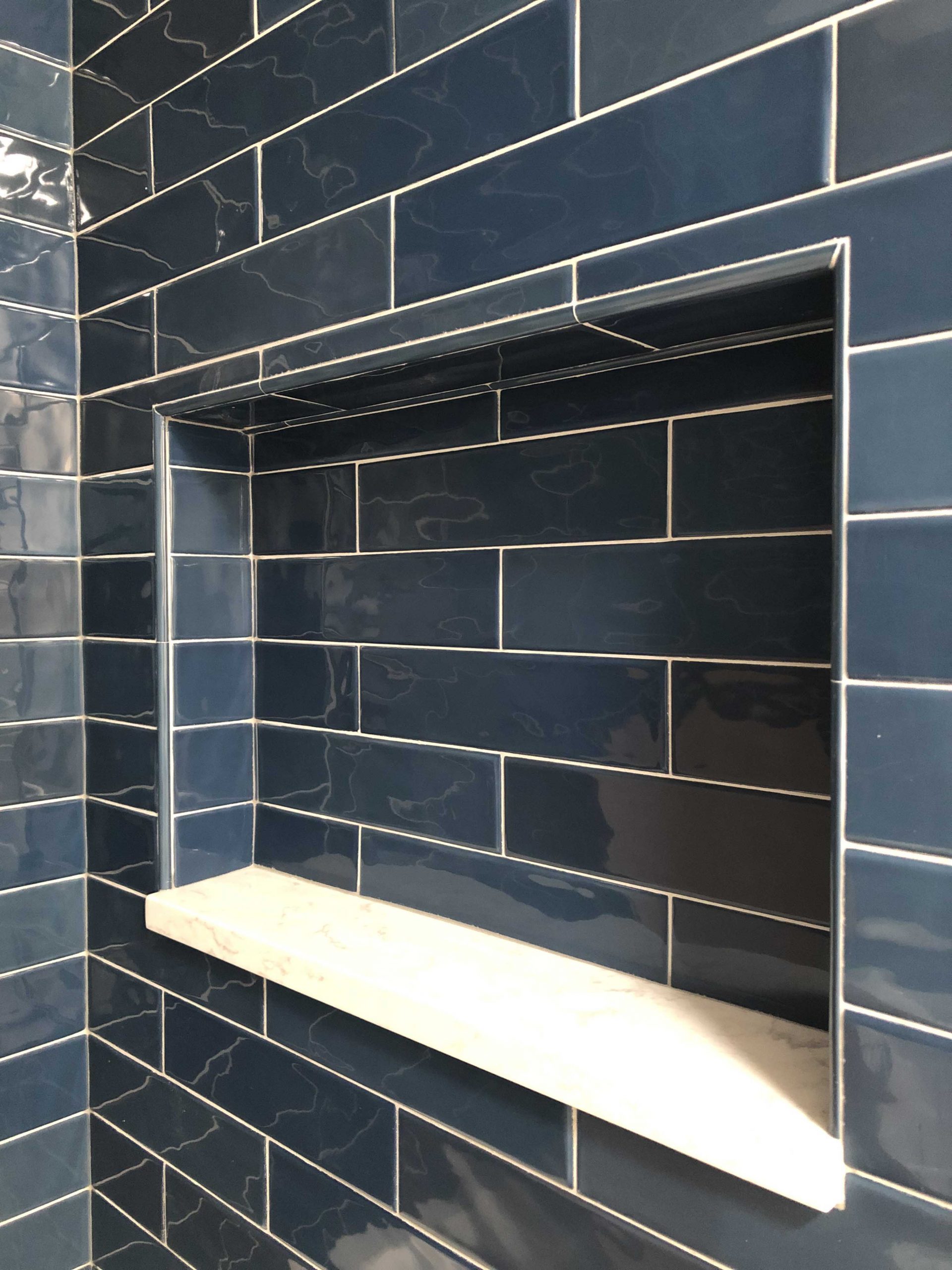 Shower niche in navy tile