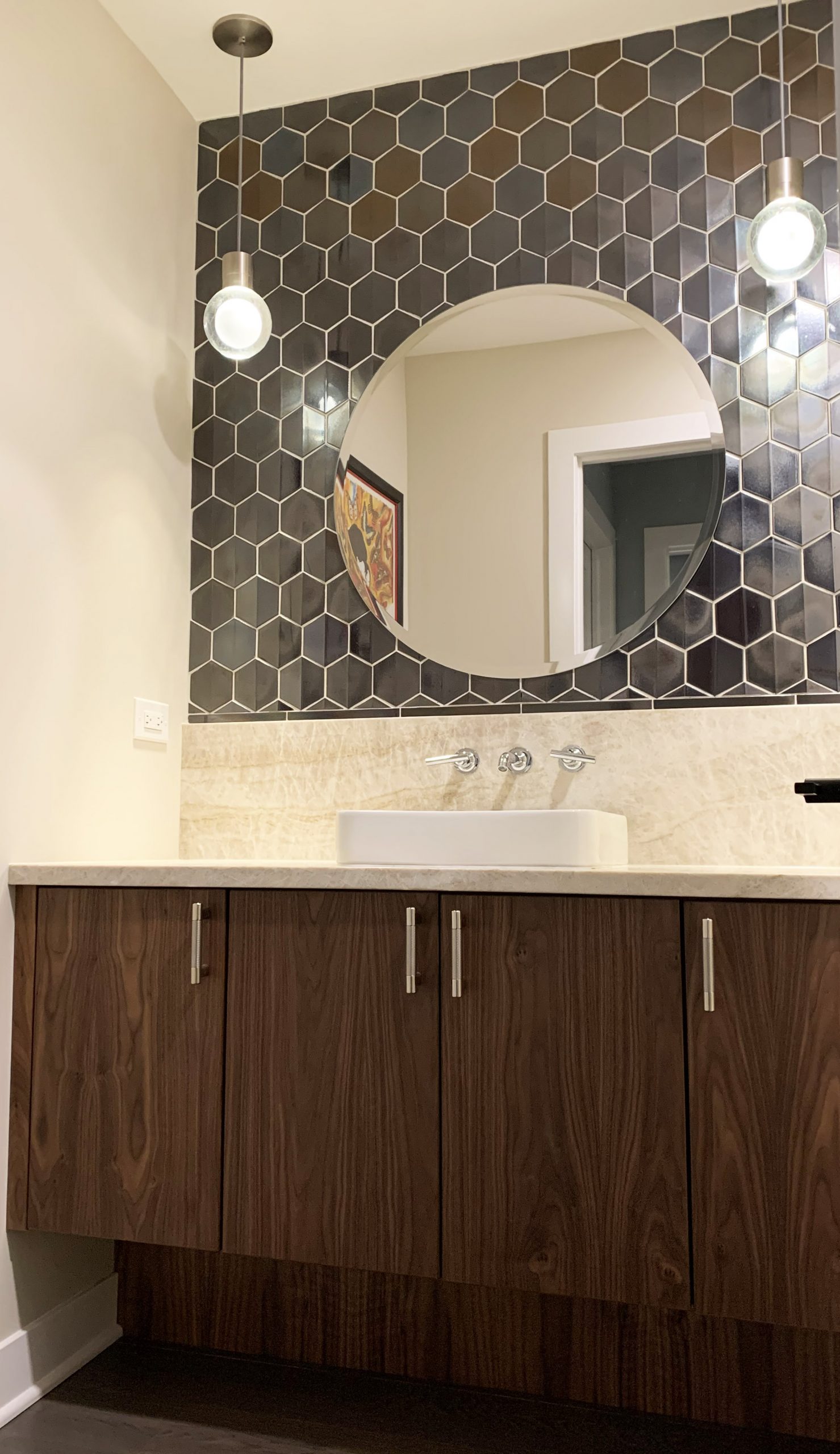 Modern powder room with drop in sink, accent tile wall, pendant lights