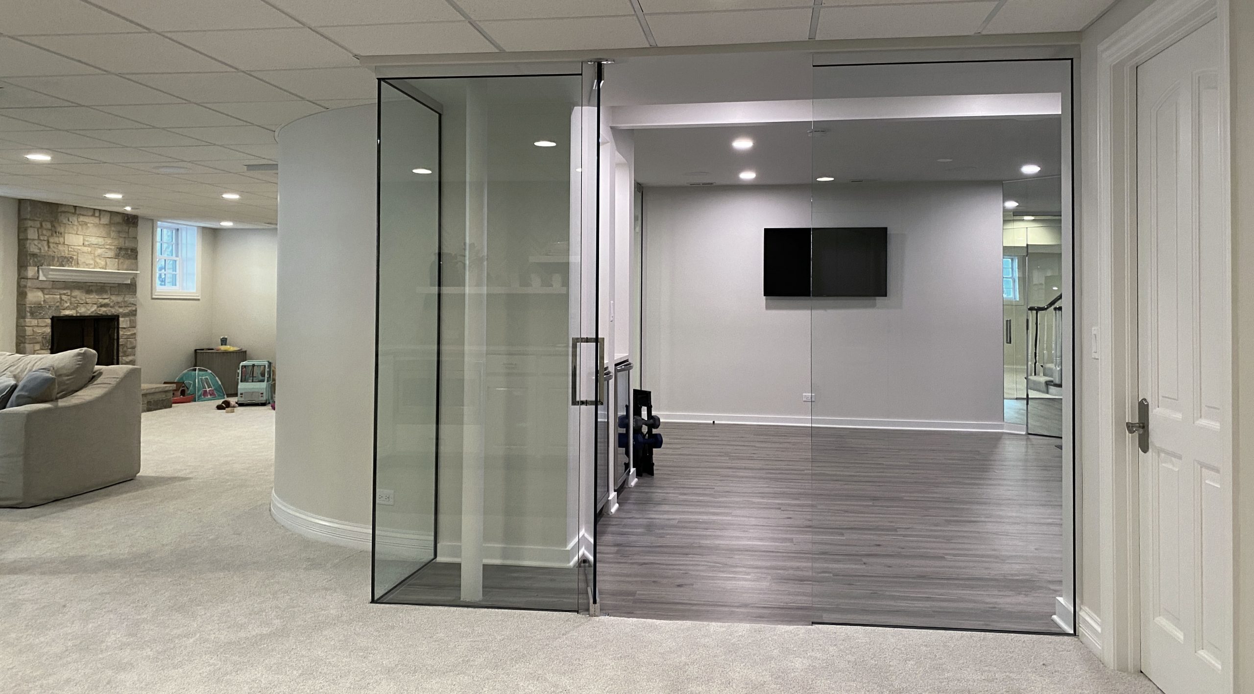 Glass walled workout room in basement