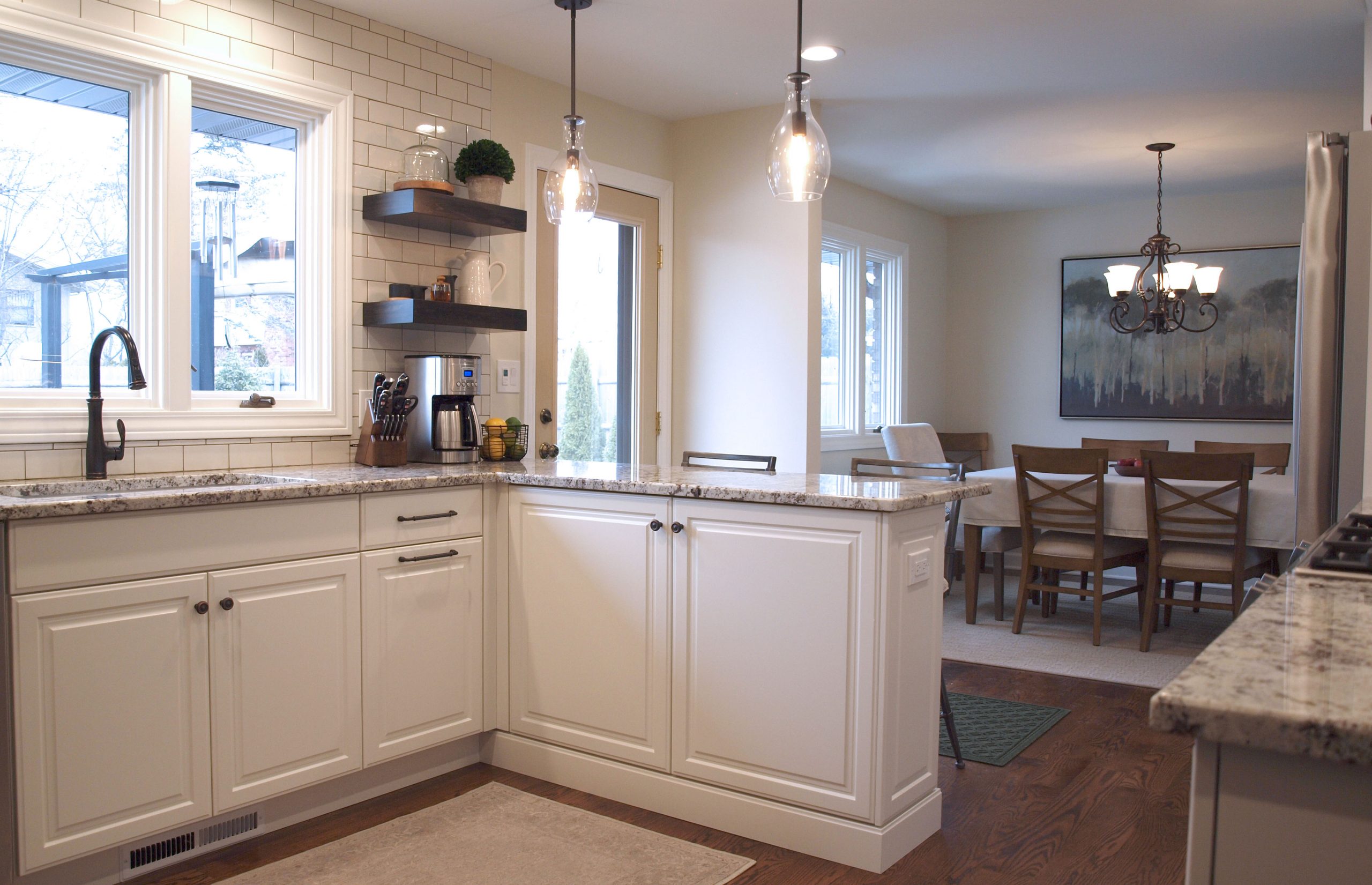 White kitchen cabinetry with floating shelves