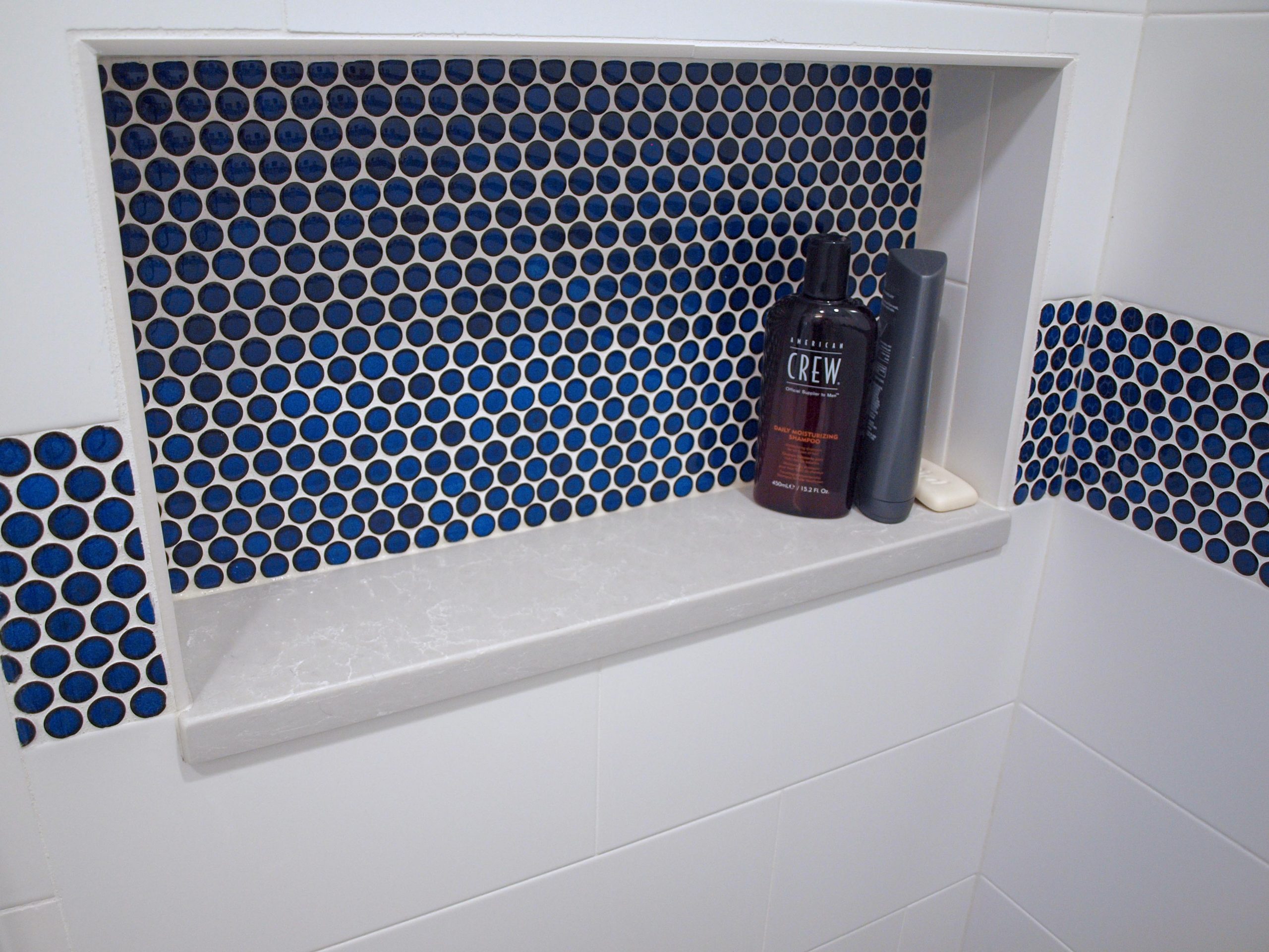 Blue penny tile stripe and shower niche