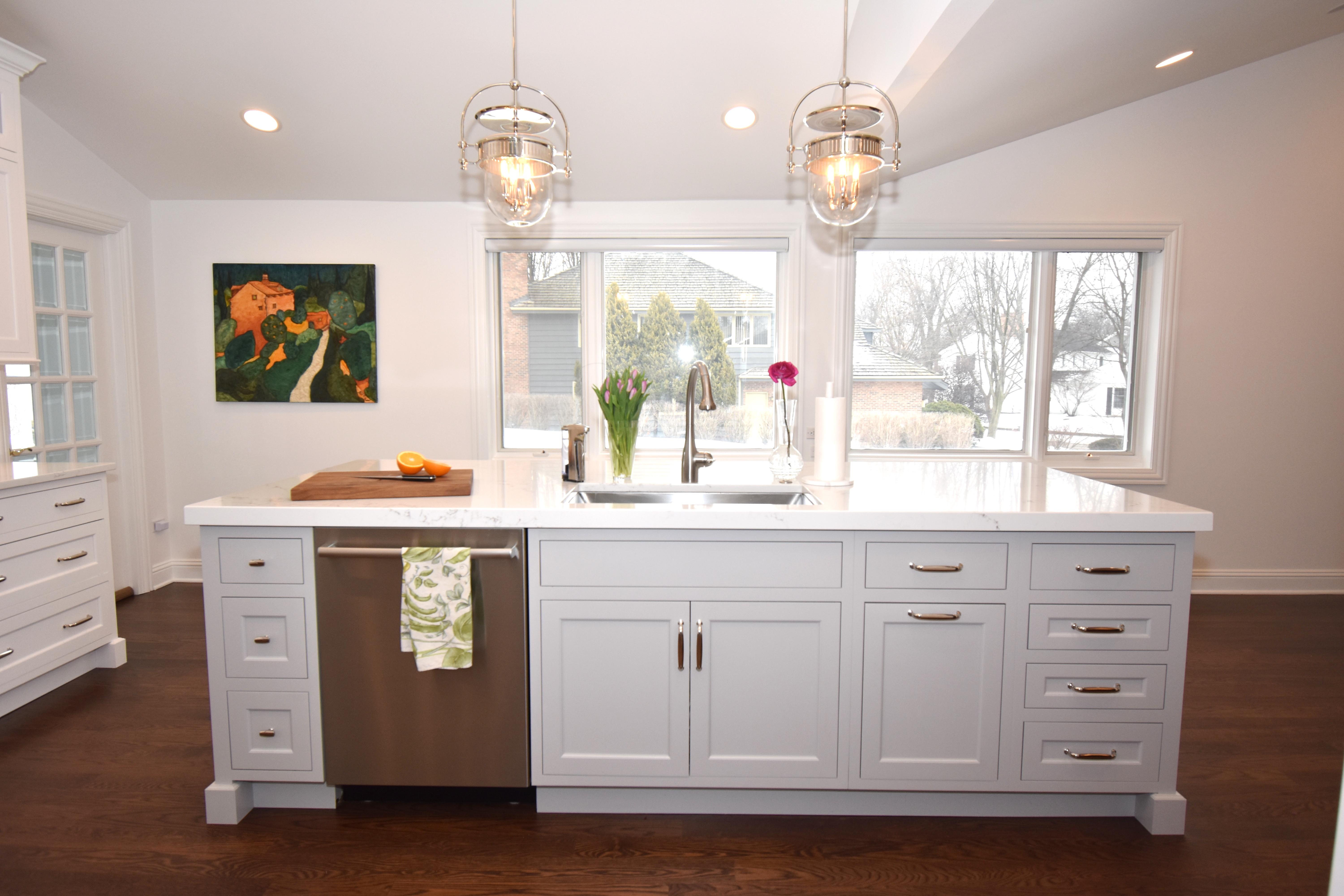 A white painted kitchen island with sink