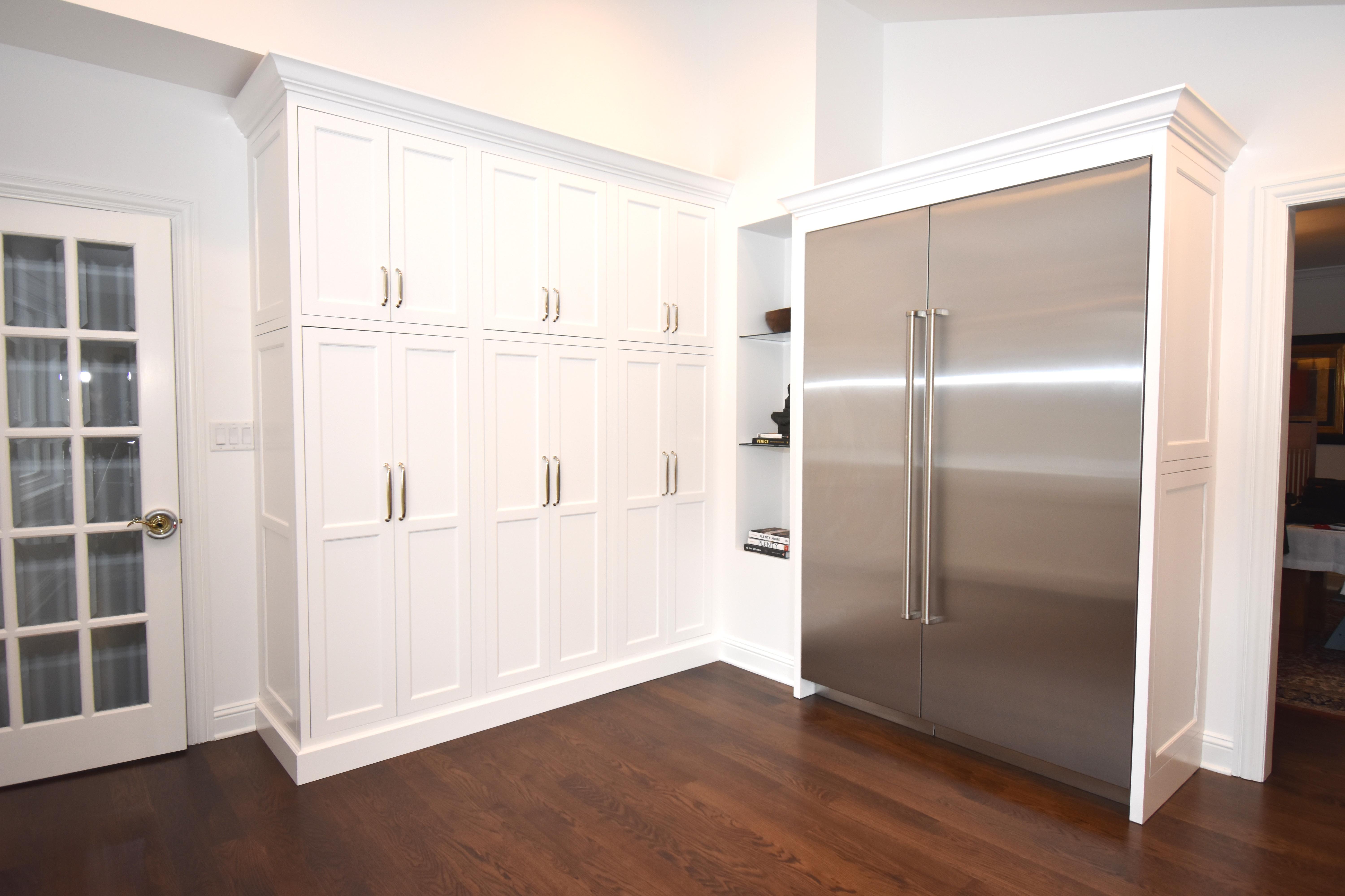 Large refrigerator in a white painted kitchen