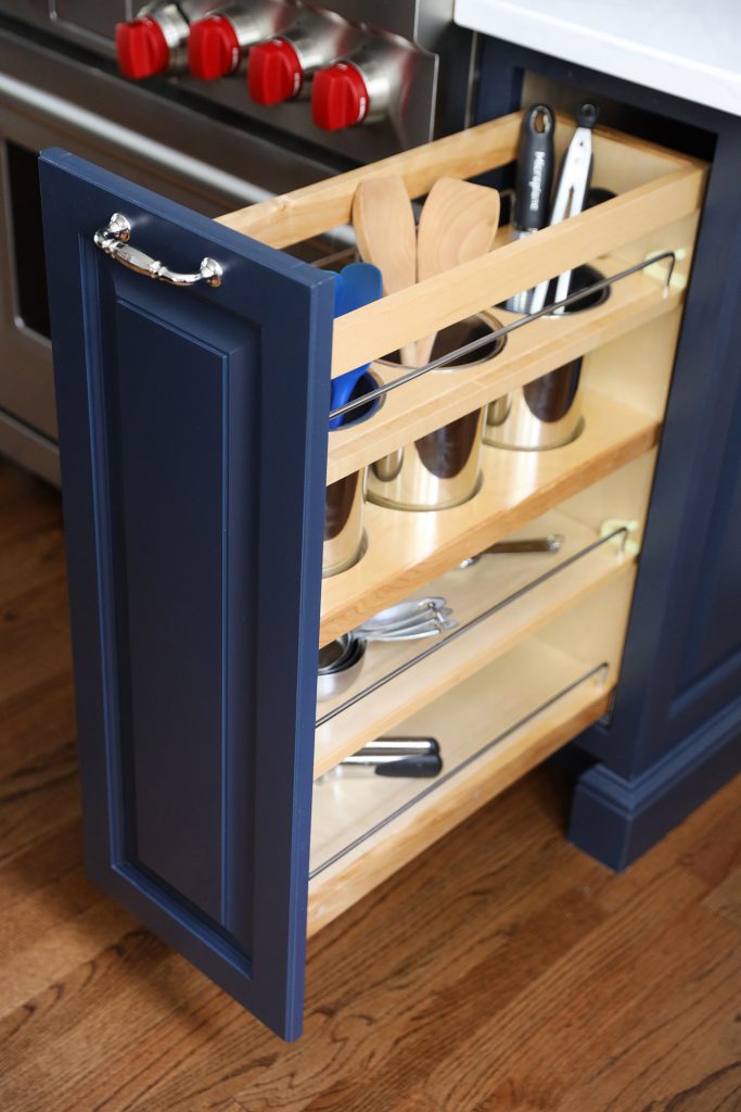 Blue kitchen cabinets with pull out organizer