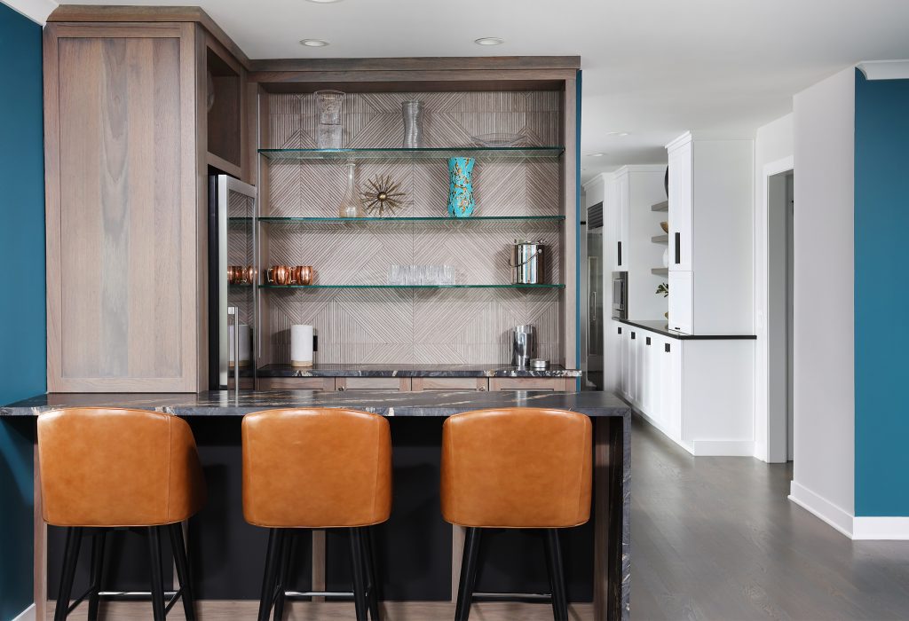 bar with waterfall edge counter and textured tile backsplash with beverage cooler