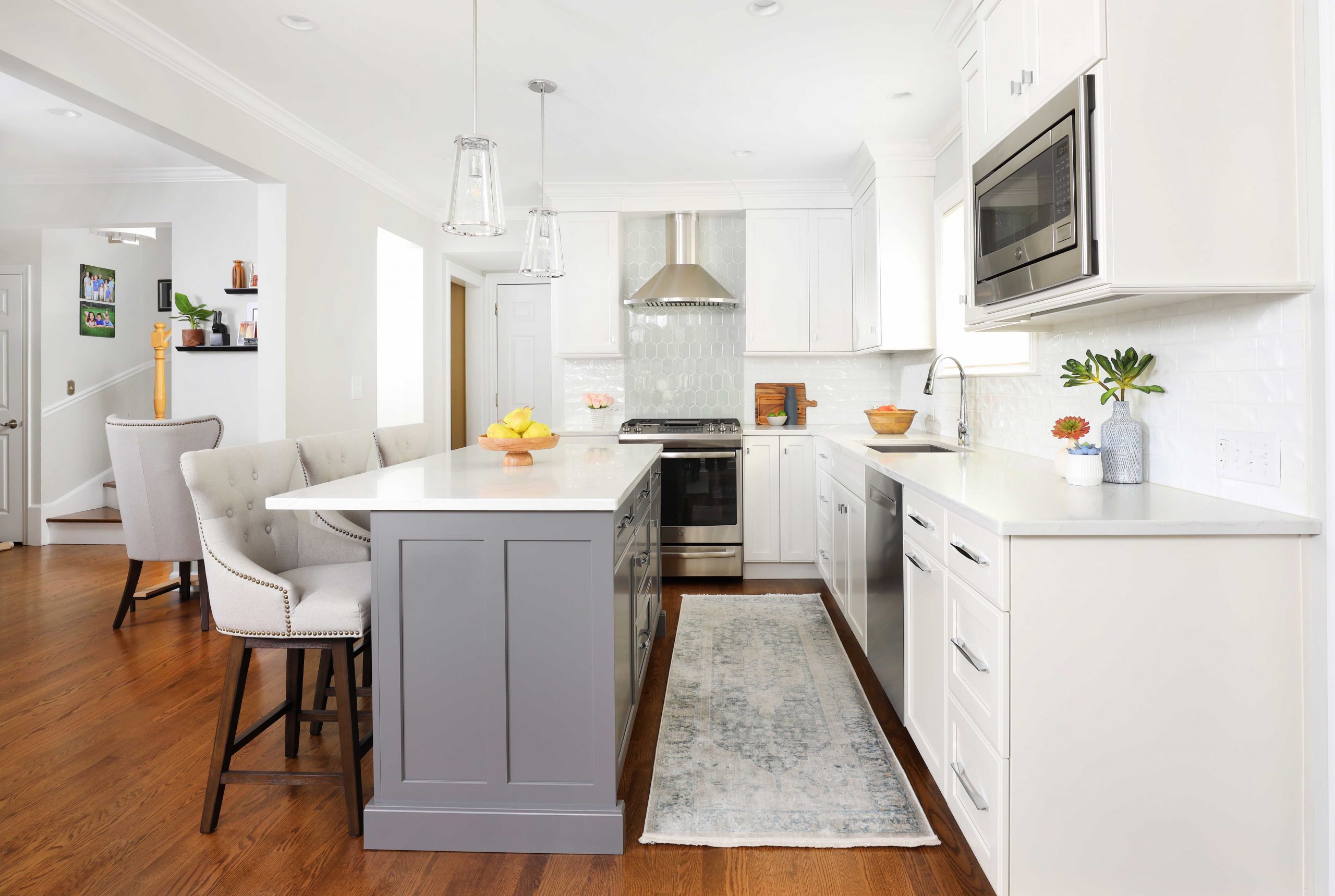 White kitchen with gray island and blue tile accents