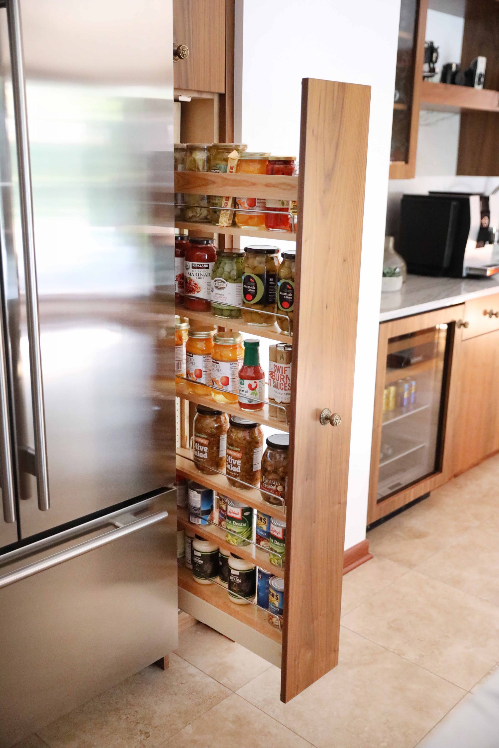 Pull out vertical pantry storage next to the fridge