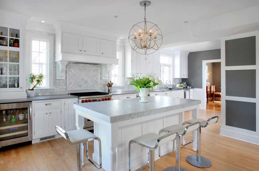 all white kitchen with island featuring quartz countertop