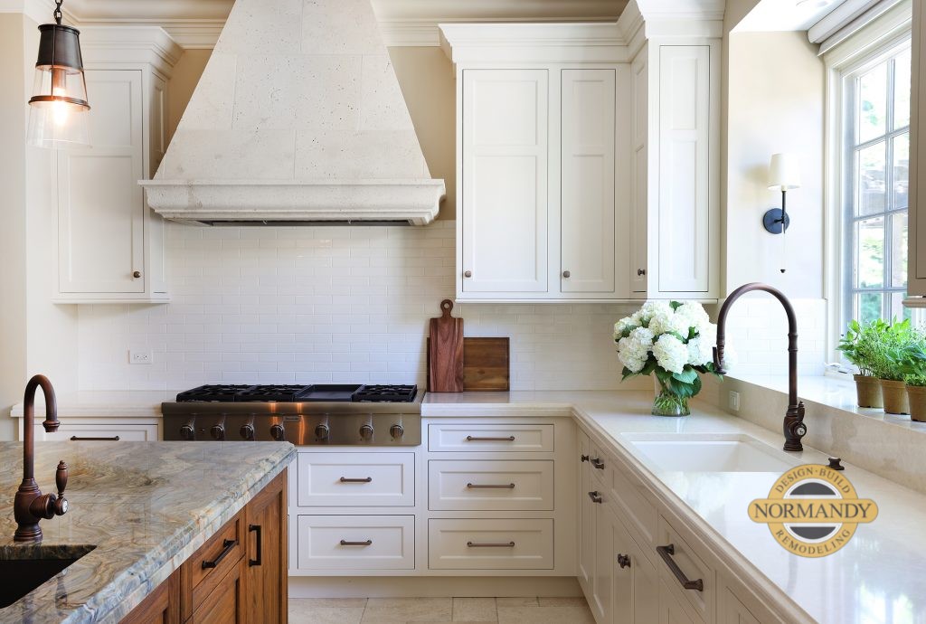 Light painted cabinets with a stone hood