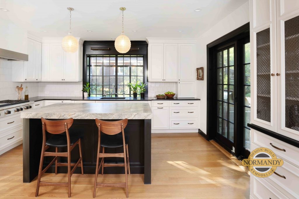 White kitchen with black window trim, black door and island