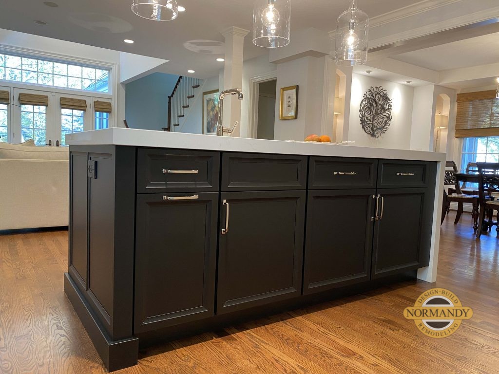 Dark kitchen island with white waterfall edge top