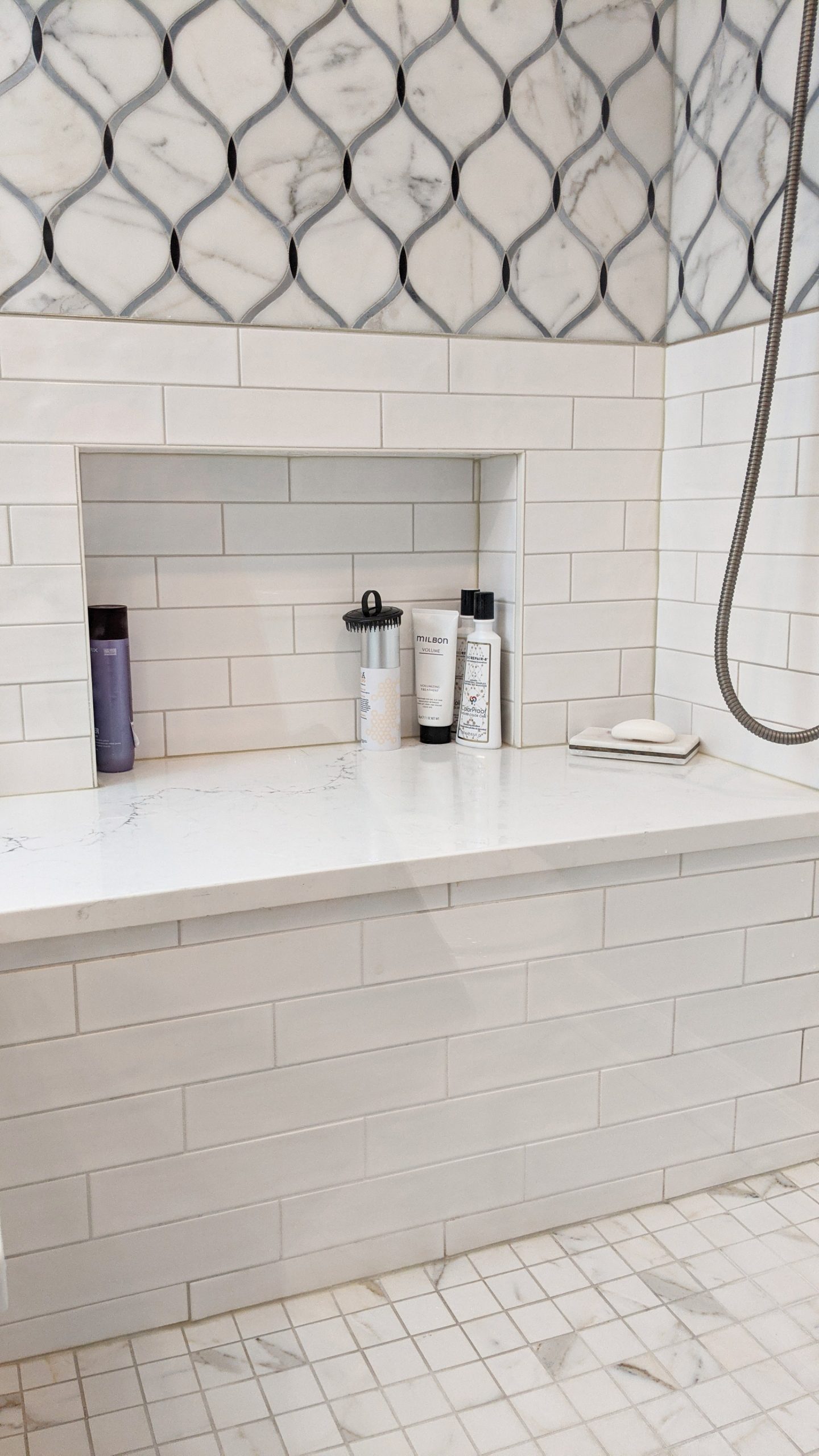 white shower subway tile installed in a 1/3 offset pattern