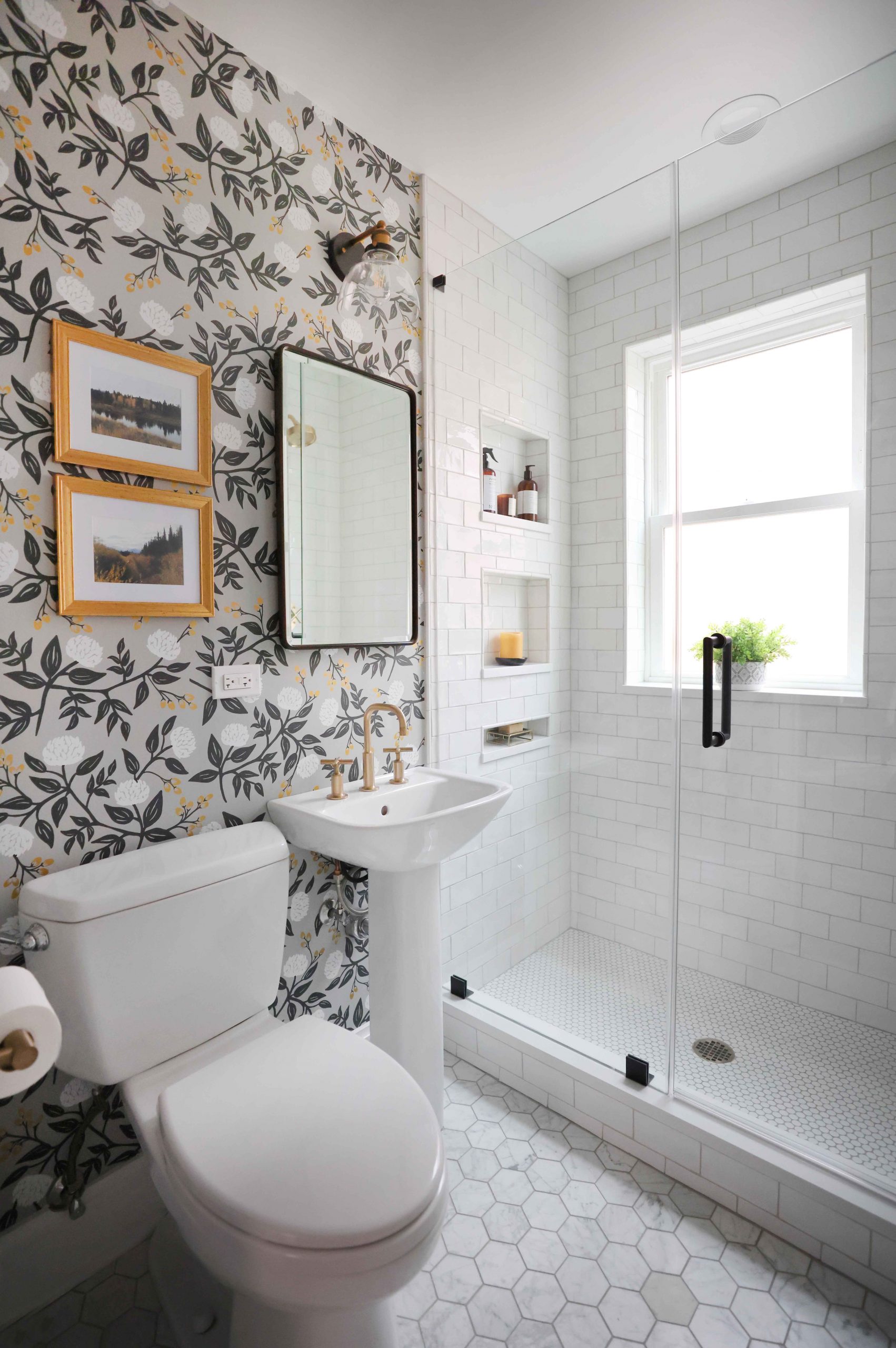 Small bathroom with pedestal sink and shower