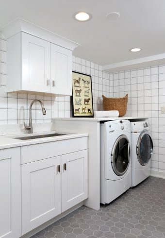 Basement laundry room, shelf over the washer and dryer, sink, under sink storage cabinets, upper cabinets