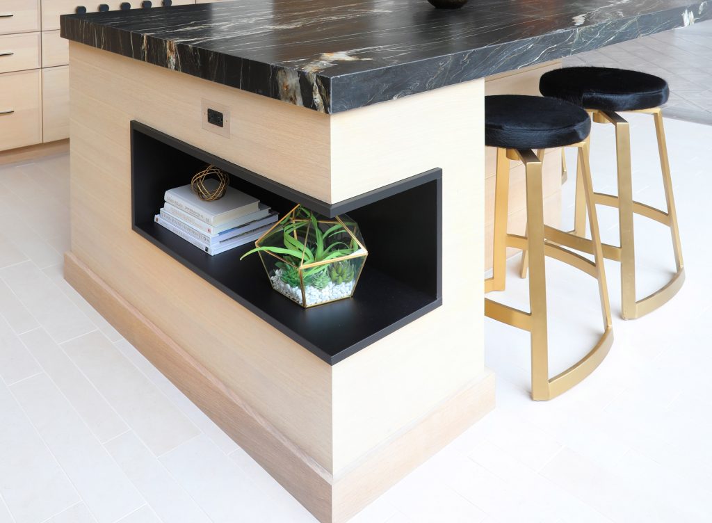 modern kitchen island with light oak, dark countertop and open shelf on end cap