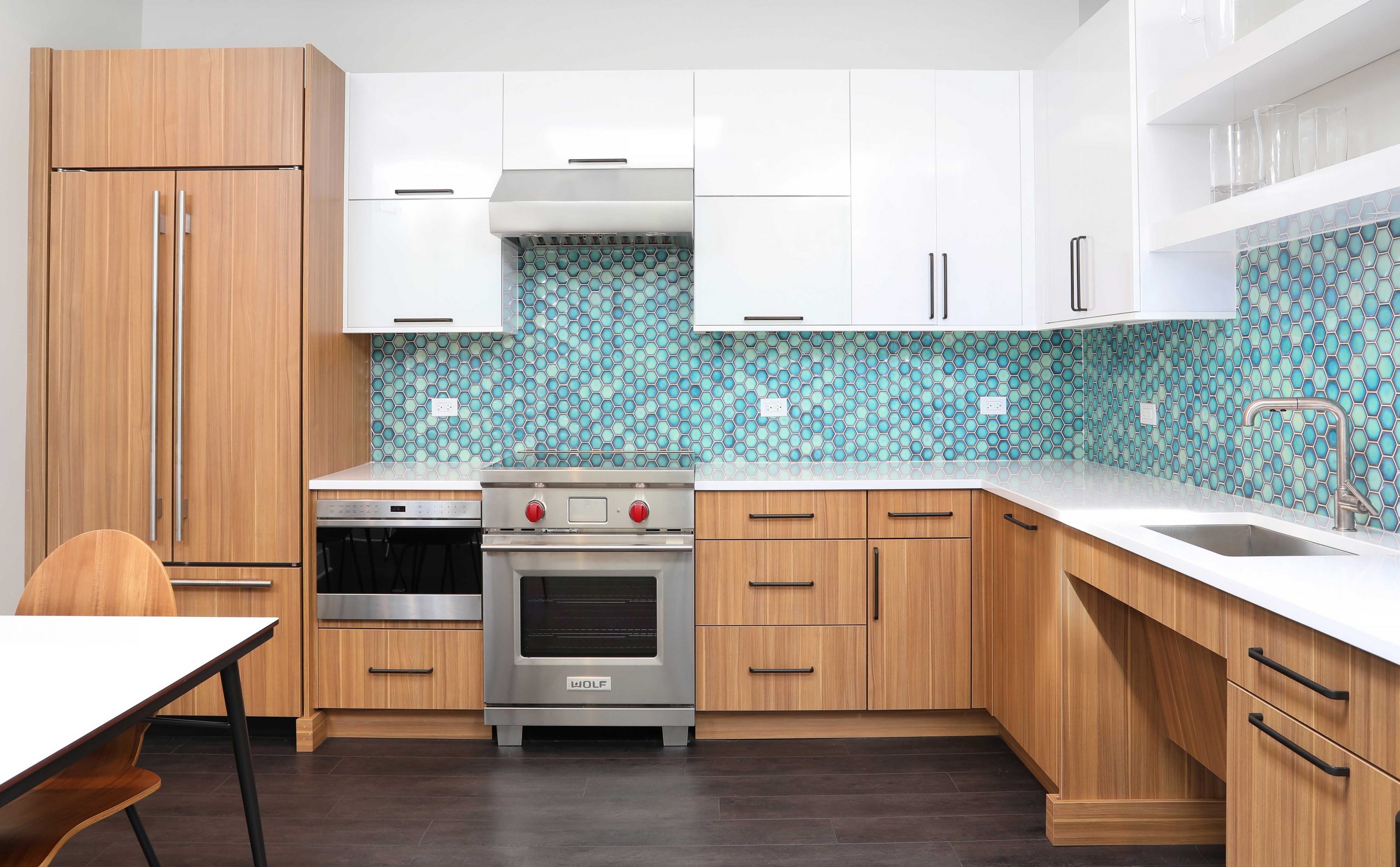 Laminate kitchen cabinets with bright blue green backsplash