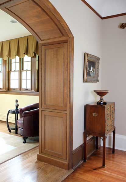 arched doorway with decorative wood paneling