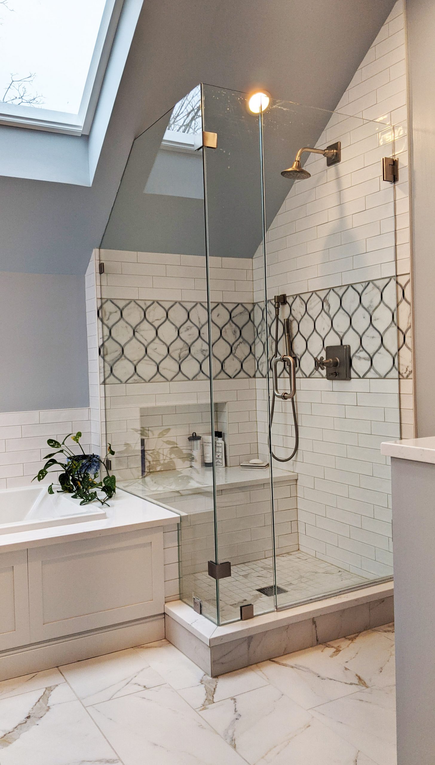 white shower subway tile installed in a 1/3 offset pattern, large floor tile in 1/3 offset