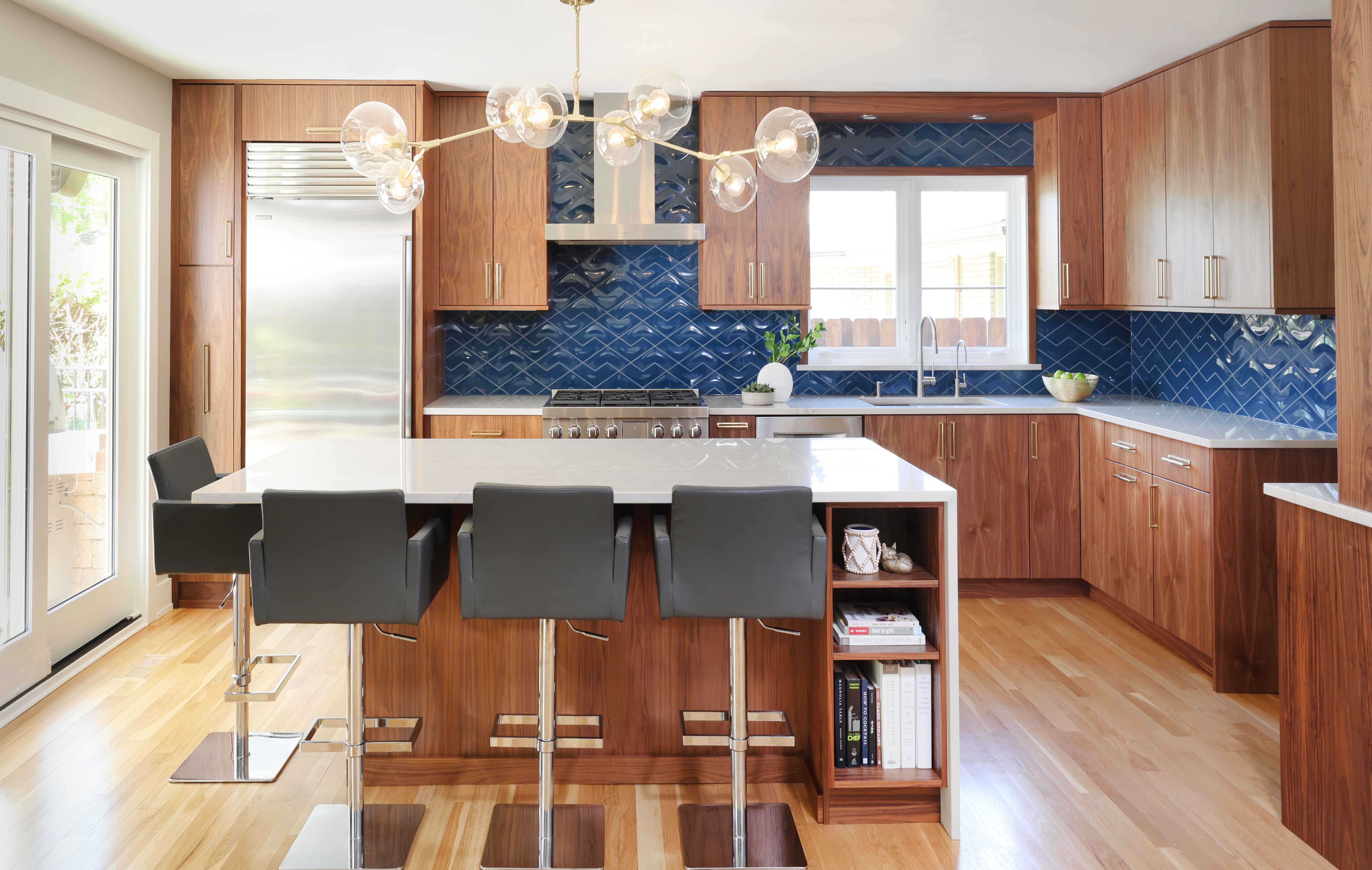 MCM wood stained kitchen with blue tile backsplash and island