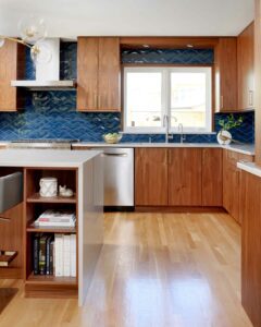 midcentury modern kitchen with waterfall edge island and blue backsplash tile