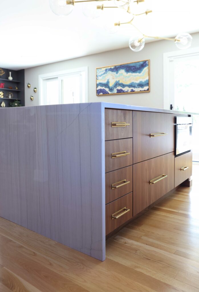 modern kitchen island with waterfall edge with gold hardware