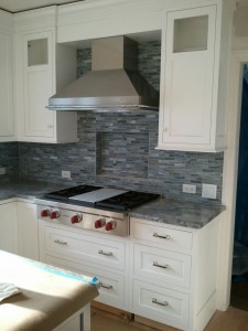 White kitchen cabinetry blue tile backsplash created by Normandy Designer Leslie Lee