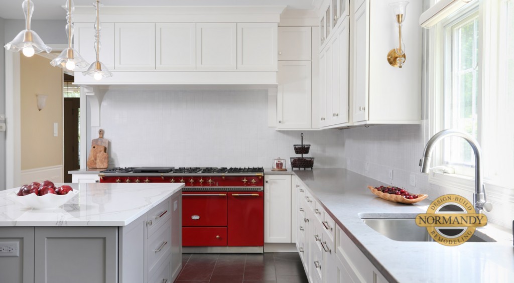 A red stove is the obvious focal point in this white kitchen