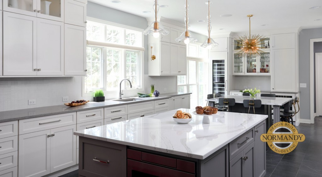 White and gray kitchen with two islands, one for prep and another for dining