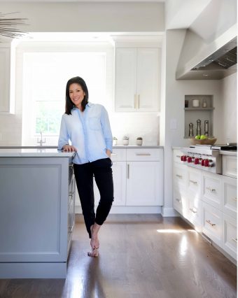 Homeowner in her new kitchen by Normandy Remodeling