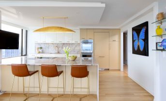 Sleek and modern condo kitchen with gold accents