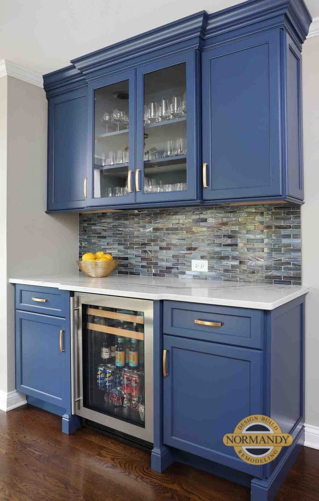 Beautiful Bar area with blue cabinets and accent tile