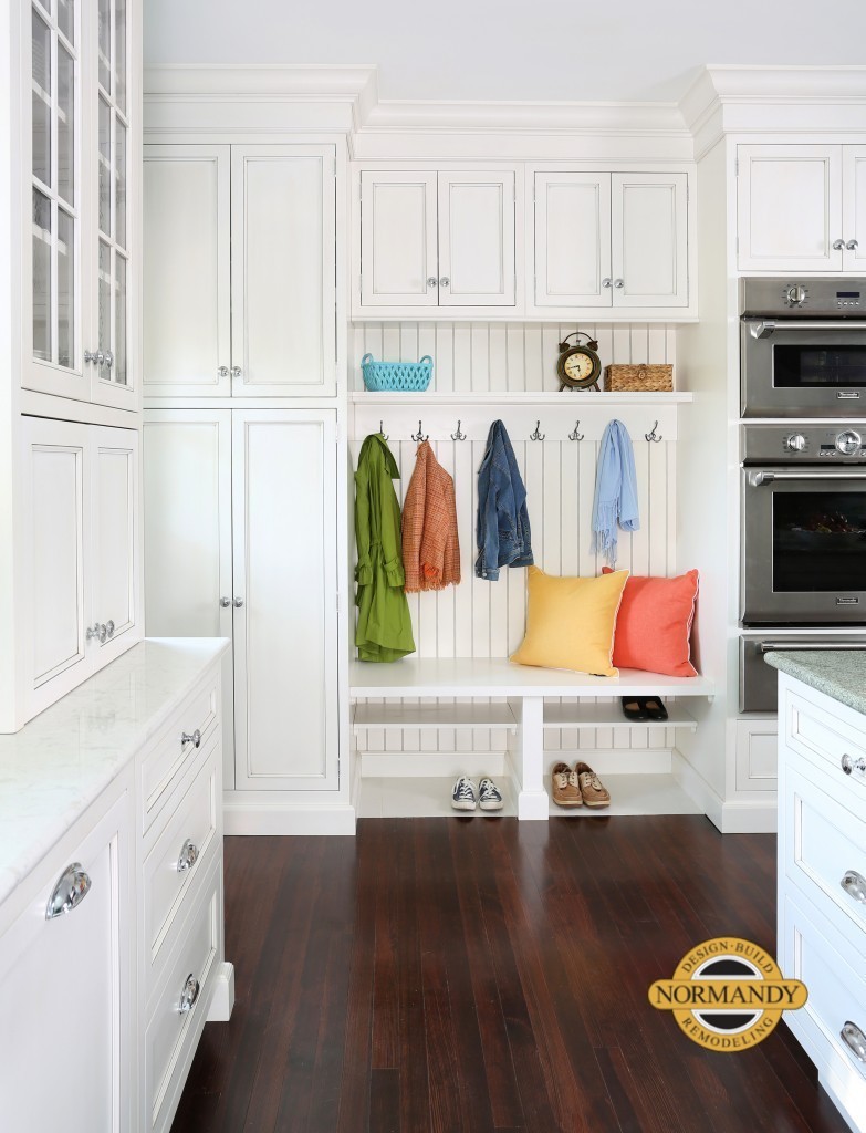 Mudroom space with bead board inside a white kitchen