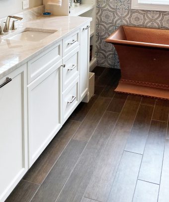 Wood plank floor tiles in a 1/3 offset pattern in bathroom