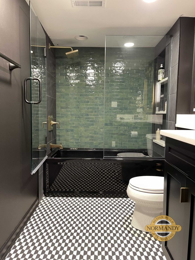 Emerald green accent tile wall in a black bathroom