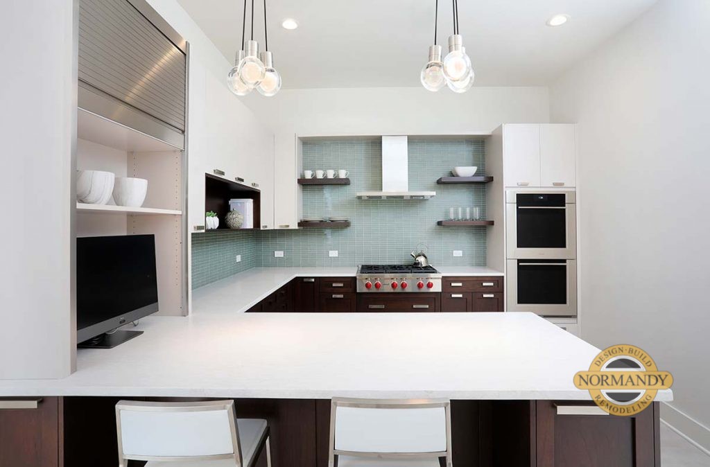 modern kitchen with blue tiled walls and wood cabinets and peninsula