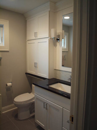 Wood bathroom vanity, bidet toilet and banjo countertop in a small bathroom