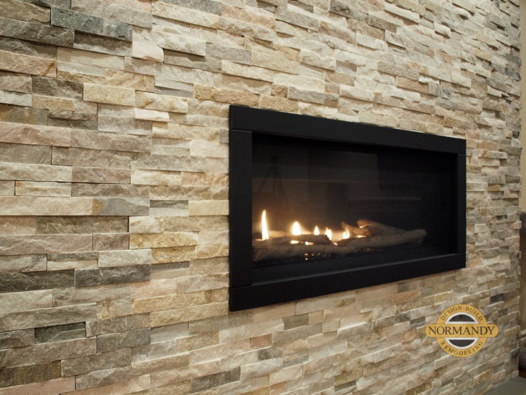 living room with stack stone wall fireplace