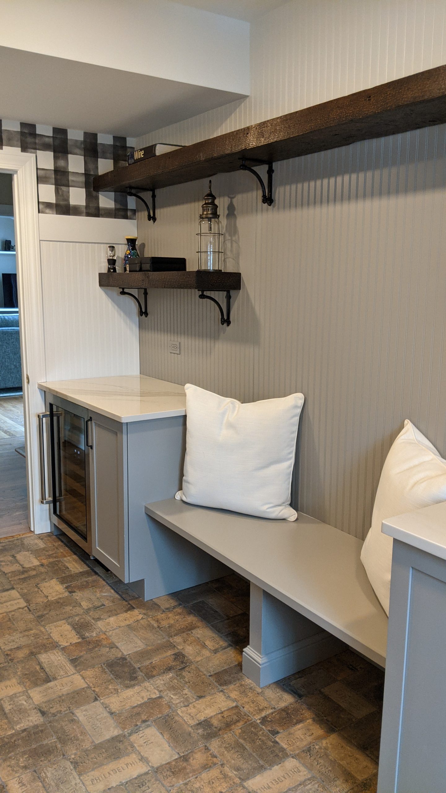 open shelving, bnech and wine cooler in mudroom