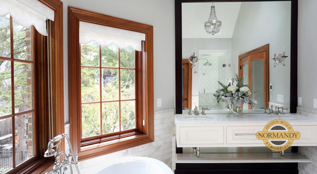 Bathroom with painted cabinets and stained window trim