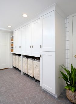 Laundry room, floor to ceiling cabinets, laundry sorting storage, upper cabinets, gold hardware