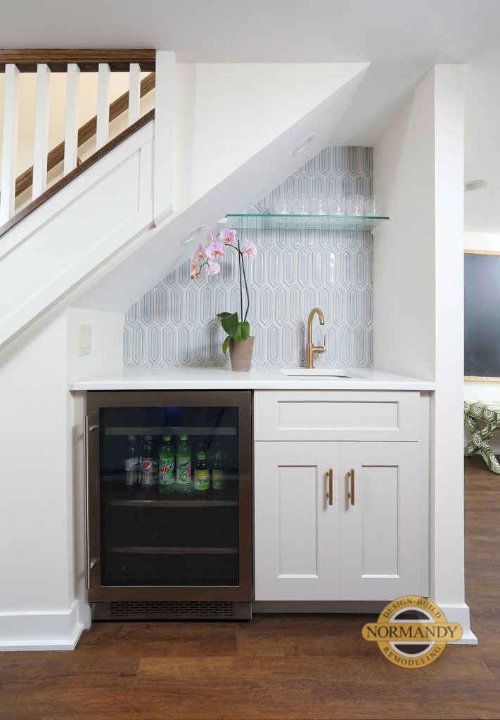 Wet bar and beverage center in the basement under the stairs