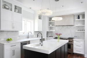 Glamorous white kitchen featuring shiny metal accents