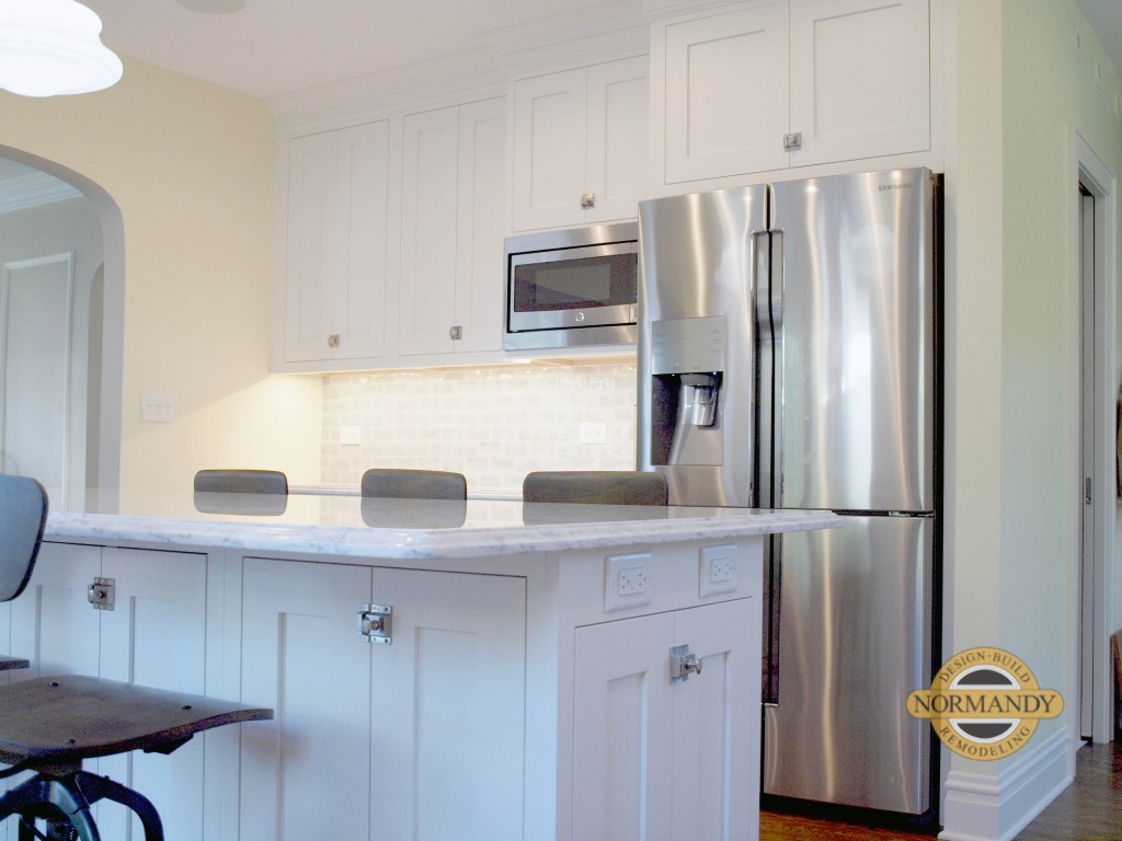 white kitchen with seating at the island